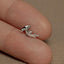 a person is holding a small silver ring