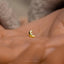 a tiny gold crescent ring on someone's hand