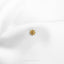 a close up of a white shirt with a gold brooch