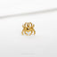 a gold crab brooch sitting on top of a white surface