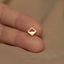 a person's finger with a gold ring on it