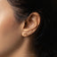 a close up of a woman's ear with a nose piercing