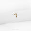 a single gold letter on a white napkin