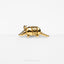 a gold plated animal brooch with a long tail