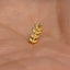 a small gold leaf on a person's hand