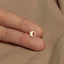 a person's hand with a gold ring on it