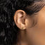 a close up of a person's ear with a gold earring
