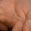 a close up of a person's hand holding a ring