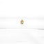 a close up of a white shirt with a gold ring on it
