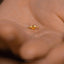 a person's hand with a gold ring on it