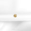 a close up of a gold brooch on a white cloth