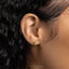 a close up of a person's ear wearing a gold earring