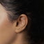 a close up of a person's ear with a nose piercing