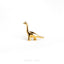 a gold brooch depicting a dinosaur on a white background