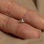 a close up of a person's hand with a ring on it