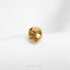 a gold skull ring on a white surface