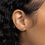 a close up of a person's ear with a gold earring