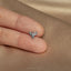 a person's hand with a ring on it