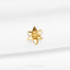 a close up of a gold brooch on a white cloth