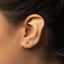 a close up of a person's ear with a diamond