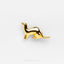 a gold kangaroo pin sitting on top of a white surface
