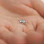 a tiny silver horse charm on a person's palm