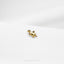 a small giraffe pin sitting on top of a white surface