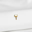 a small square shaped gold earring on a white cloth