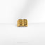 a close up of a gold ring on a white surface