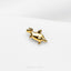 a gold giraffe brooch sitting on top of a white surface
