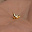 a small gold bird on a person's hand