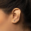 a close up of a person wearing a pair of ear piercings