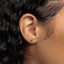 a close up of a person's ear wearing a gold earring