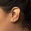 a close up of a person wearing a pair of ear piercings