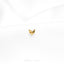 a close up of a gold earring on a white cloth