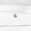 a close up of a white shirt with a gold pin