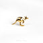 a gold kangaroo brooch sits on a white surface