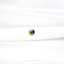 a close up of a white shirt with a gold button