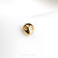 a close up of a gold ring on a white cloth