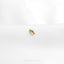 a close up of a gold ring on a white surface