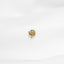 a close up of a gold ring on a white surface