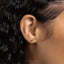 a close up of a person's ear with a gold earring