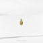 a close up of a gold earring on a white surface