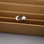 a pair of star and moon stud earrings