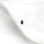 a pair of black earrings sitting on top of a white cloth