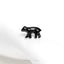 a small black bear sitting on top of a white cloth