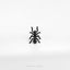 a black spider sitting on top of a white surface