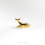 a gold whale ring on a white background