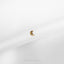 a small gold ring on a white surface