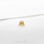 a gold crab ring on a white surface